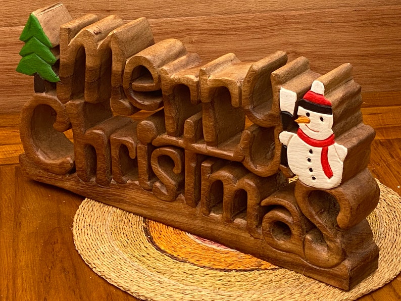 V277-WCMCD-190224-00 Wooden carved Merry Christmas decoration 38 cm long with Tree and Star - Image 1