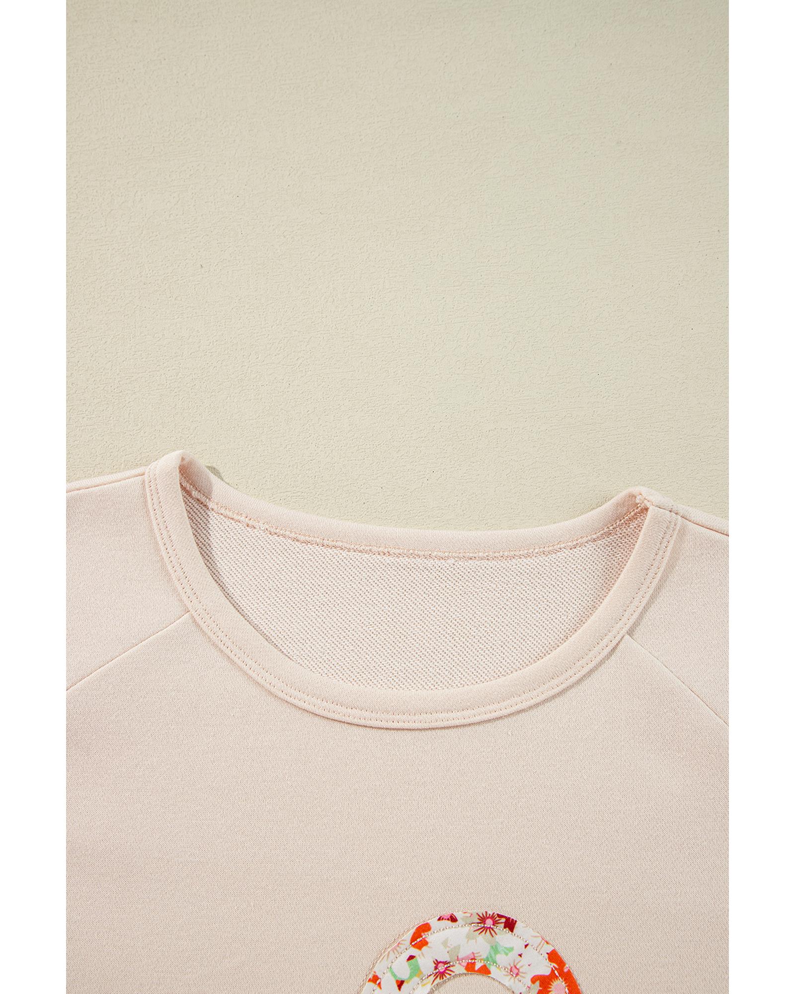 V539-AZEXDC25129068-P15-L-202506120335-00 Beige Flower Patch Graphic Exposed Seam Wide Sleeve Top - L - Image 1