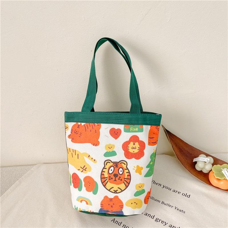 V562-2051124060DBT-202503041320-00 Cartoon Graffiti Bento Bag - Cute Canvas Handbag - Model 2 Green - Image 1